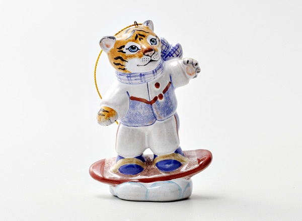 Christmas tree toy Tiger cub on a snowboard