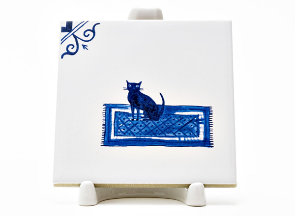Tile Dutch. Black cat on a rug 
